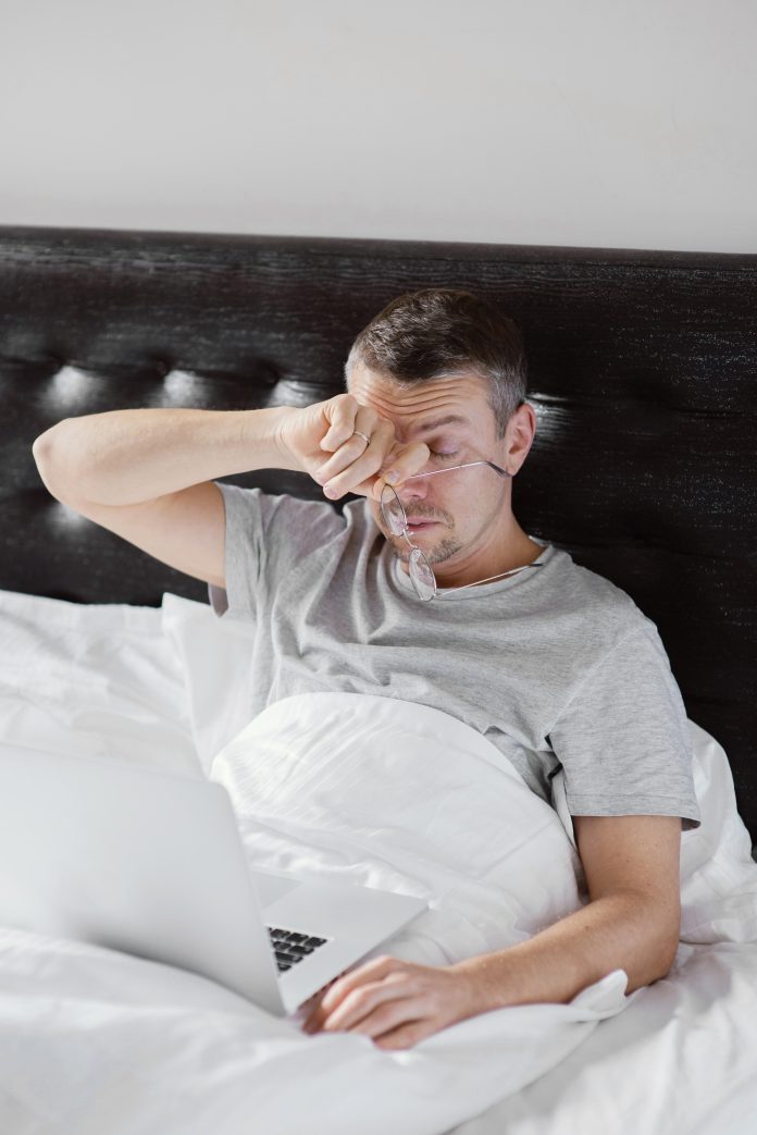 man-bed-using-laptop